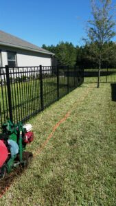 removing a marked off area of grass for a hedge privacy screen installation